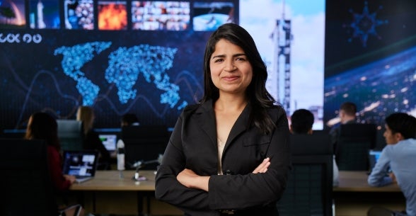 Thunderbird student standing in school's global decision theater