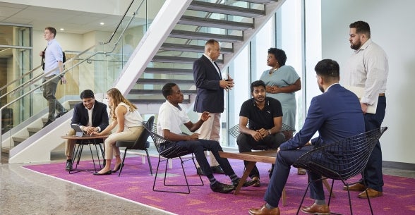 A group of graduate students talking and networking in the Asia Lounge at Thunderbird School of Global Management's new Global Headquarters.