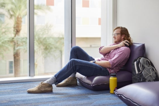 A Thunderbird student taking a moment to relax in the meditation room