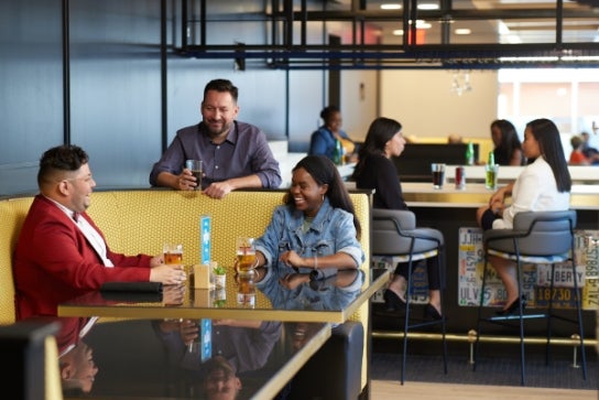Thunderbird students sit in a booth on the 5th floor pub at One Global Place