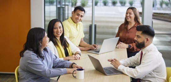 Thunderbird students sitting at a table talking