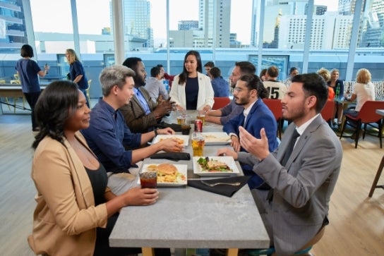Image of Thunderbird students conversing over food